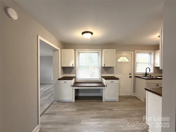 a kitchen with a stove a sink and a refrigerator