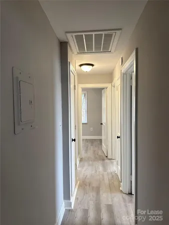 a view of a hallway with a room