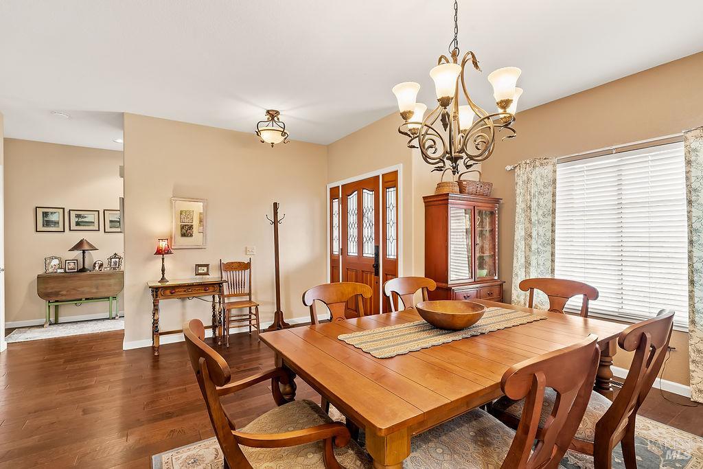 6252 Meadowstone Drive Santa Rosa, CA 95409 - Photo 21 of 33 a dining room with furniture a chandelier and wooden floor