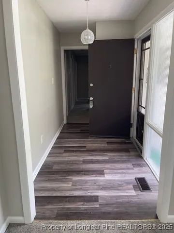 a view of a hallway view with wooden floor and staircase