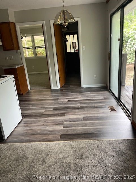 5509 Old Forge Circle Raleigh, NC 27609 - Photo 6 of 8 a view of a hallway view with wooden floor and staircase