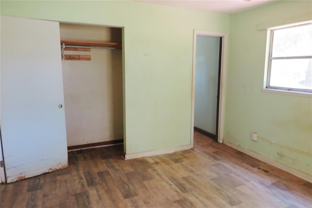 153-UNIT Ranch Road San Mateo, FL 32187 - Photo 13 of 34 a view of an empty room with wooden floor and a window