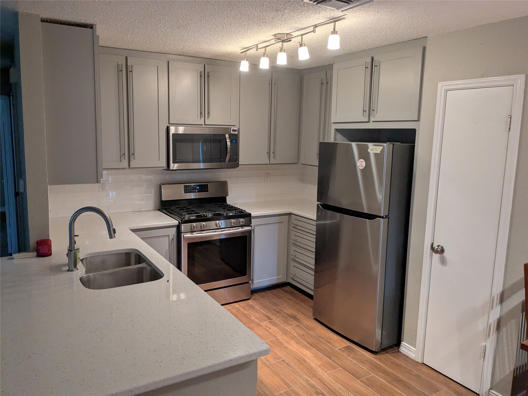 Culinary creations come to life in this kitchen, featuring ample countertop space and contemporary appliances.