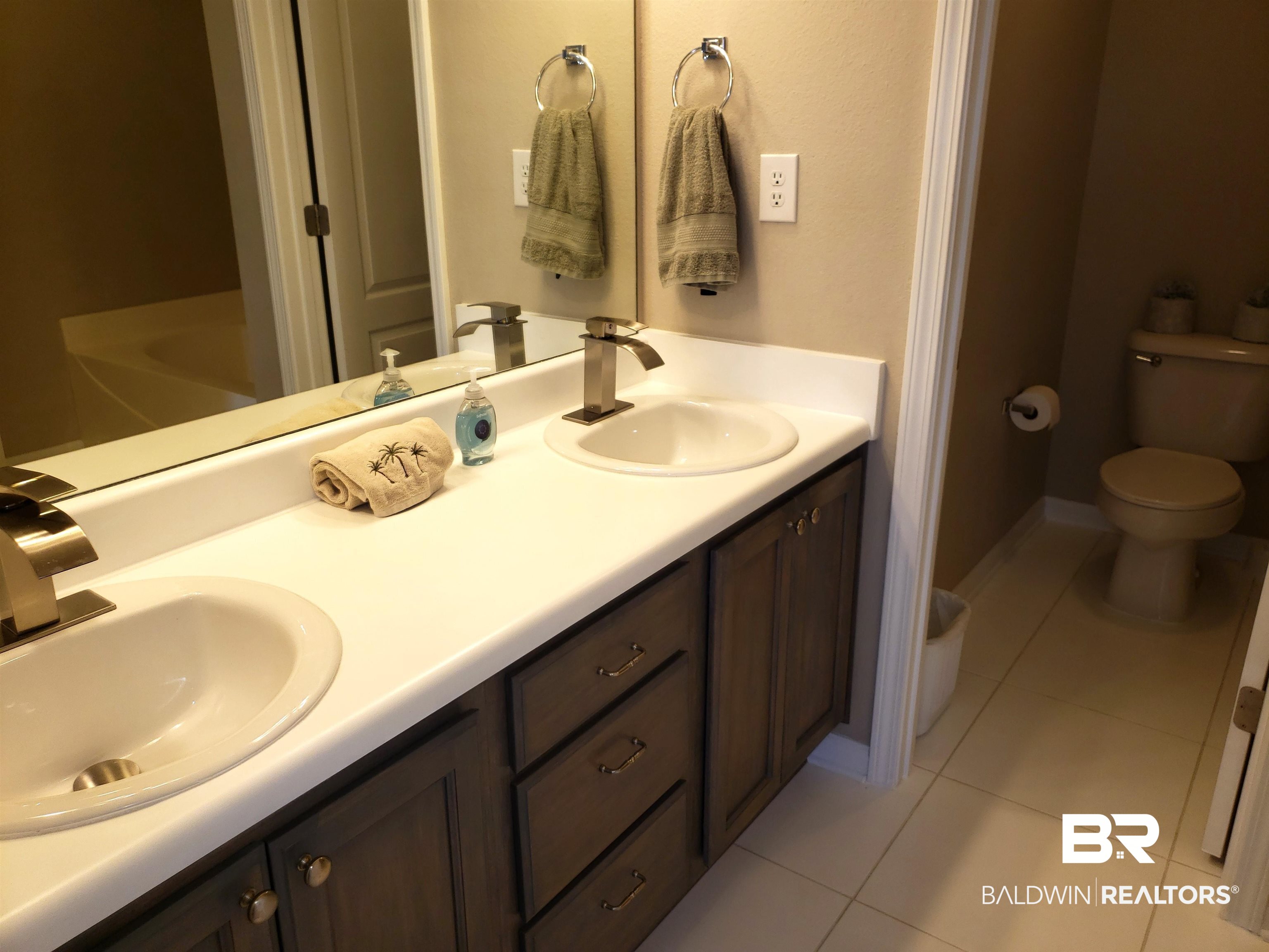 2006 Shelene Way, Unit 2006 Foley, AL 36535 - Photo 9 of 29 Full bath with tile flooring, double vanity, toilet, and a sink w/ new fixtures
