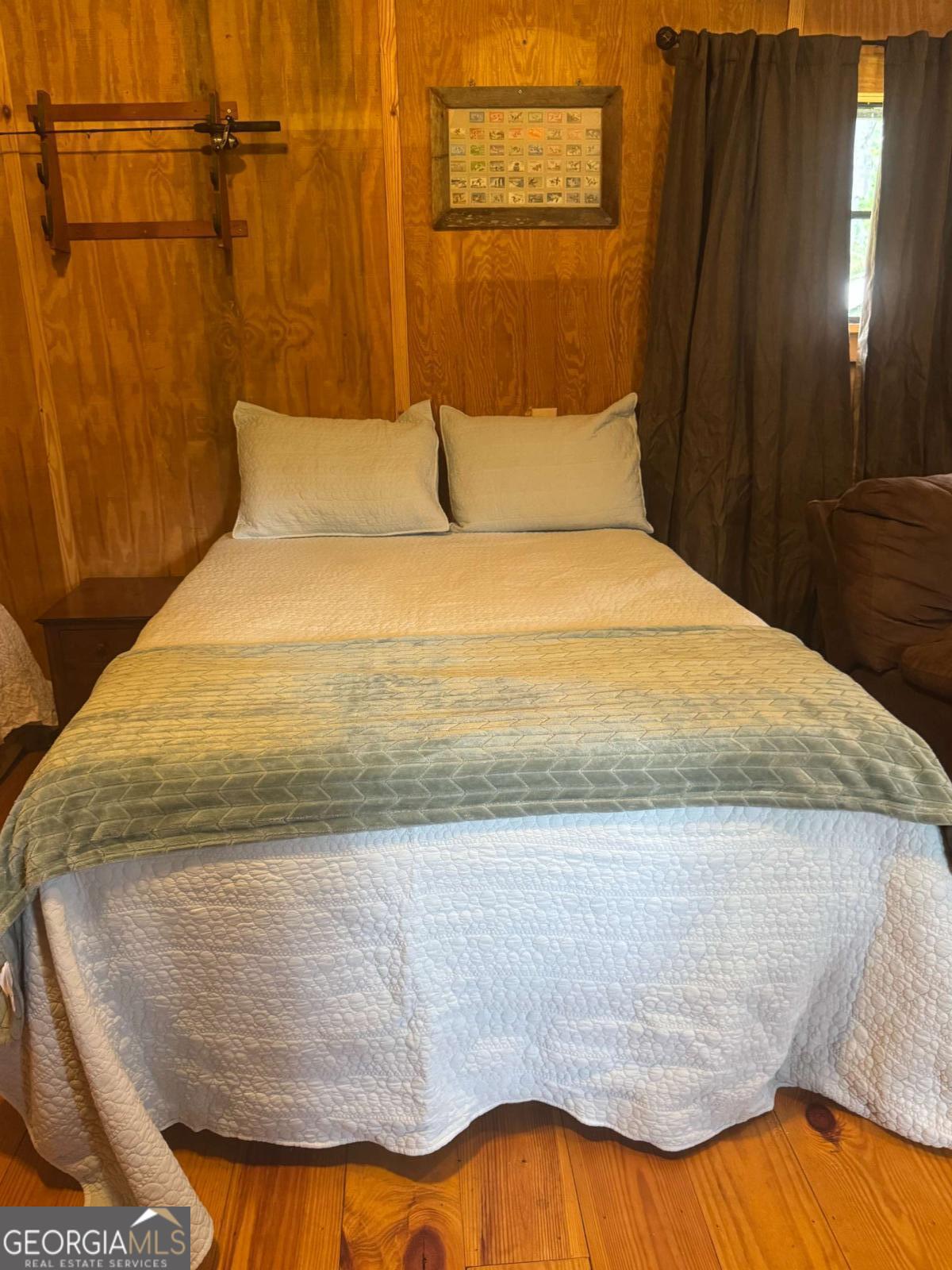 1603 Dl Durrence Road Reidsville, GA 30453 - Photo 13 of 78 a bed sitting in a bedroom next to a bathroom