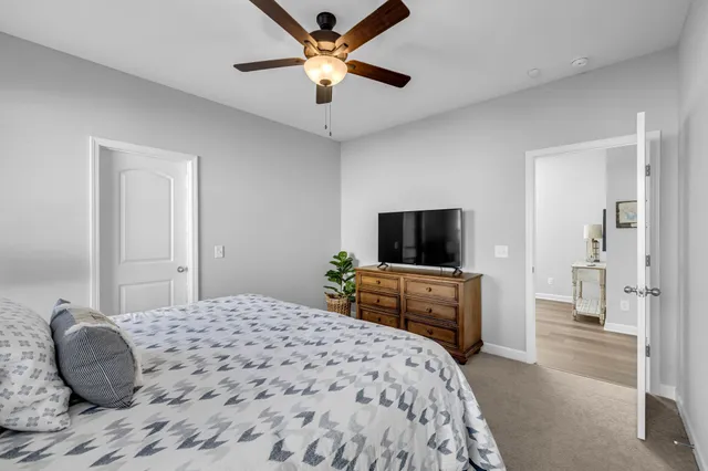 a bathroom with a shower sink vanity mirror and toilet