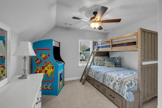 a bedroom with a bed and a flat tv screen on the dresser