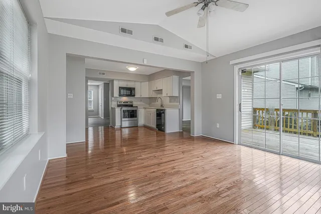 a view of empty room with wooden floor and fireplace