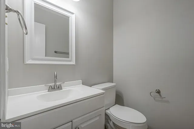 a white toilet sitting next to a bathroom sink