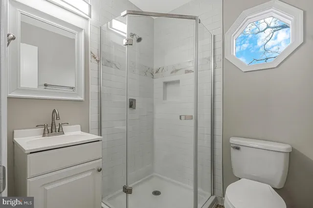 a bathroom with a toilet a sink and shower