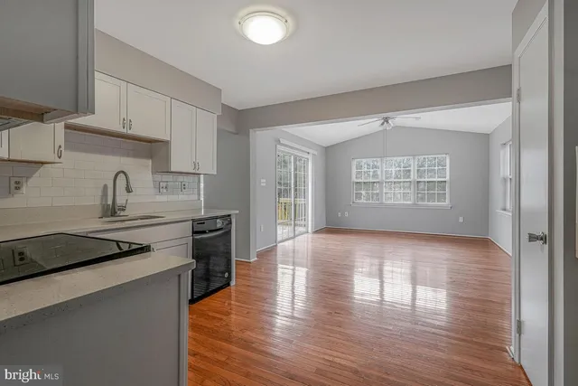 a kitchen with a wooden floor and a stove top oven