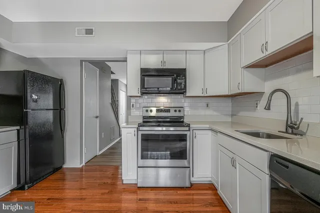 a kitchen with a sink stove and refrigerator
