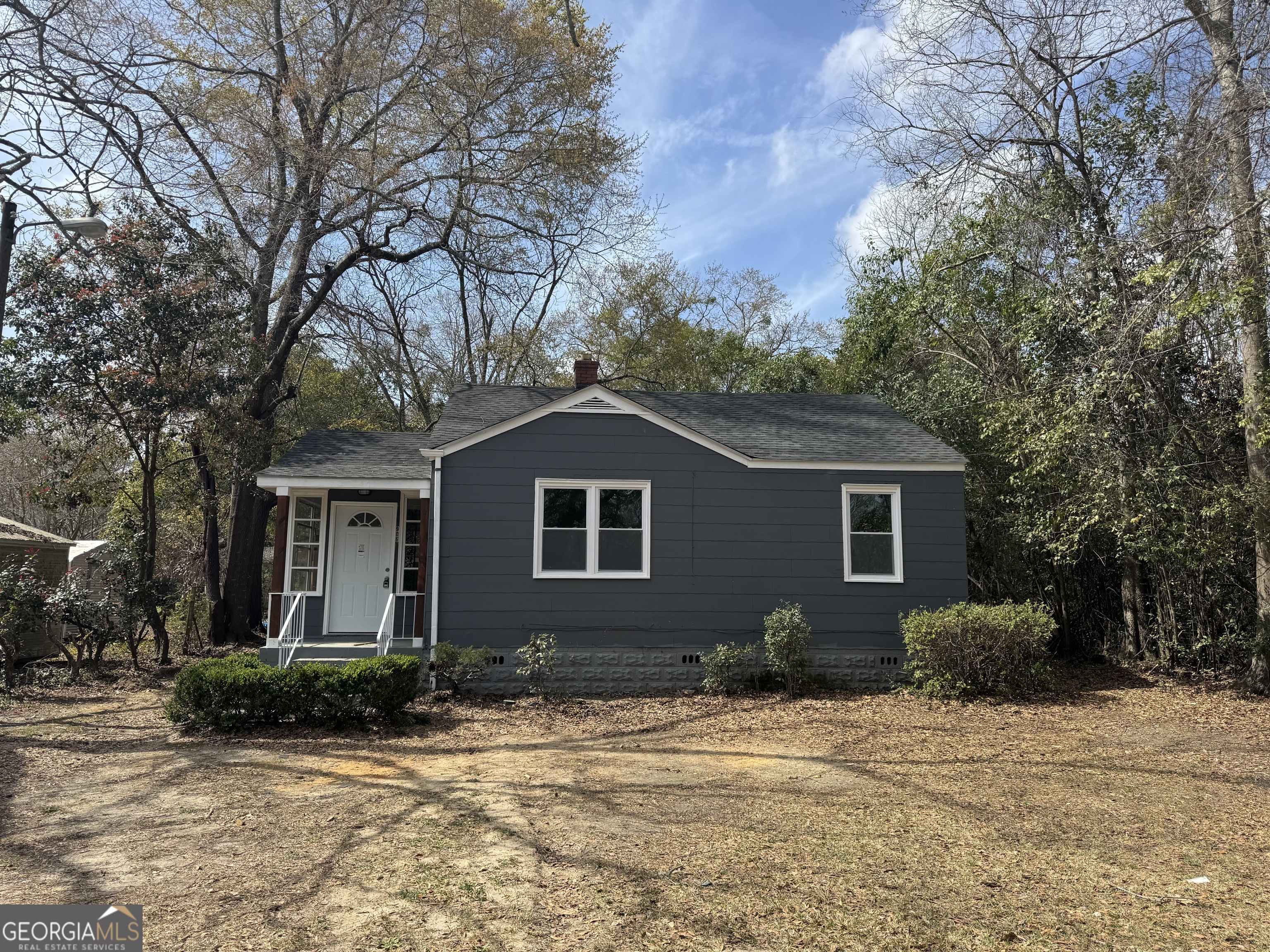 a front view of house with yard and trees