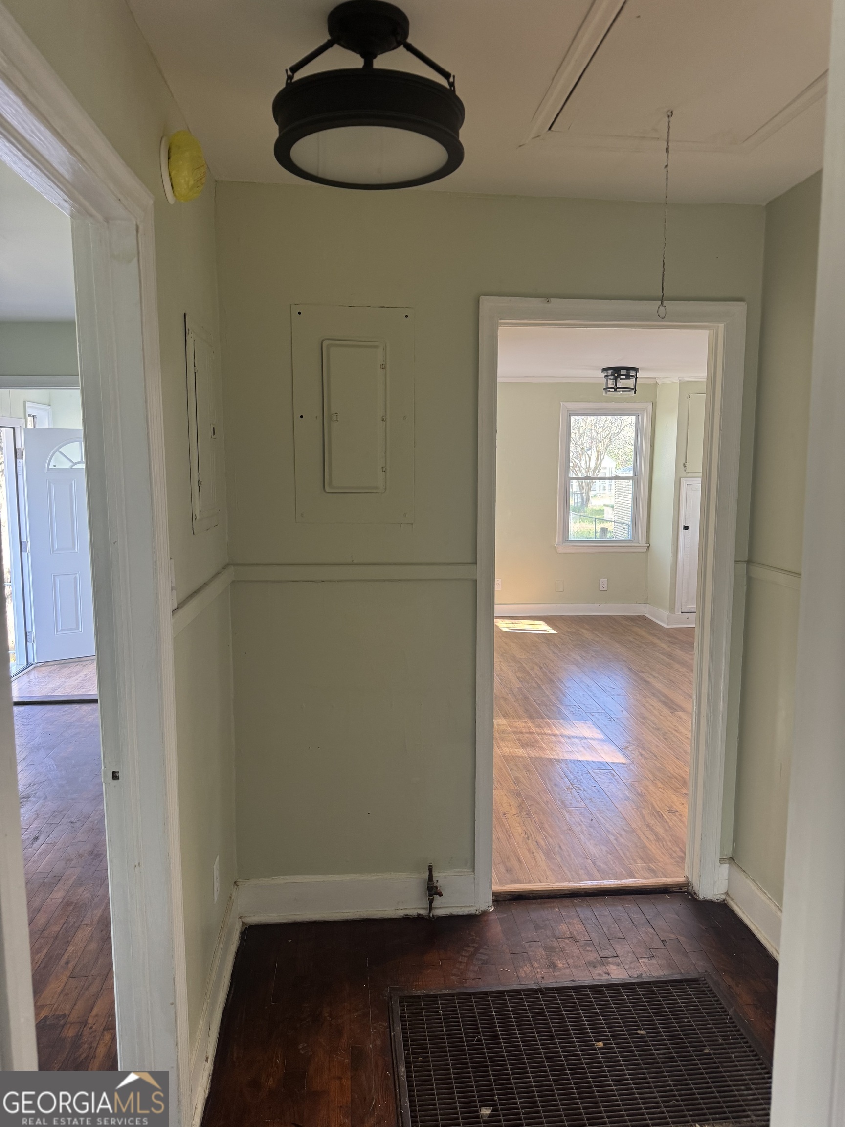 906 Central Avenue Dublin, GA 31021 - Photo 11 of 15 wooden floor in an empty room with a window