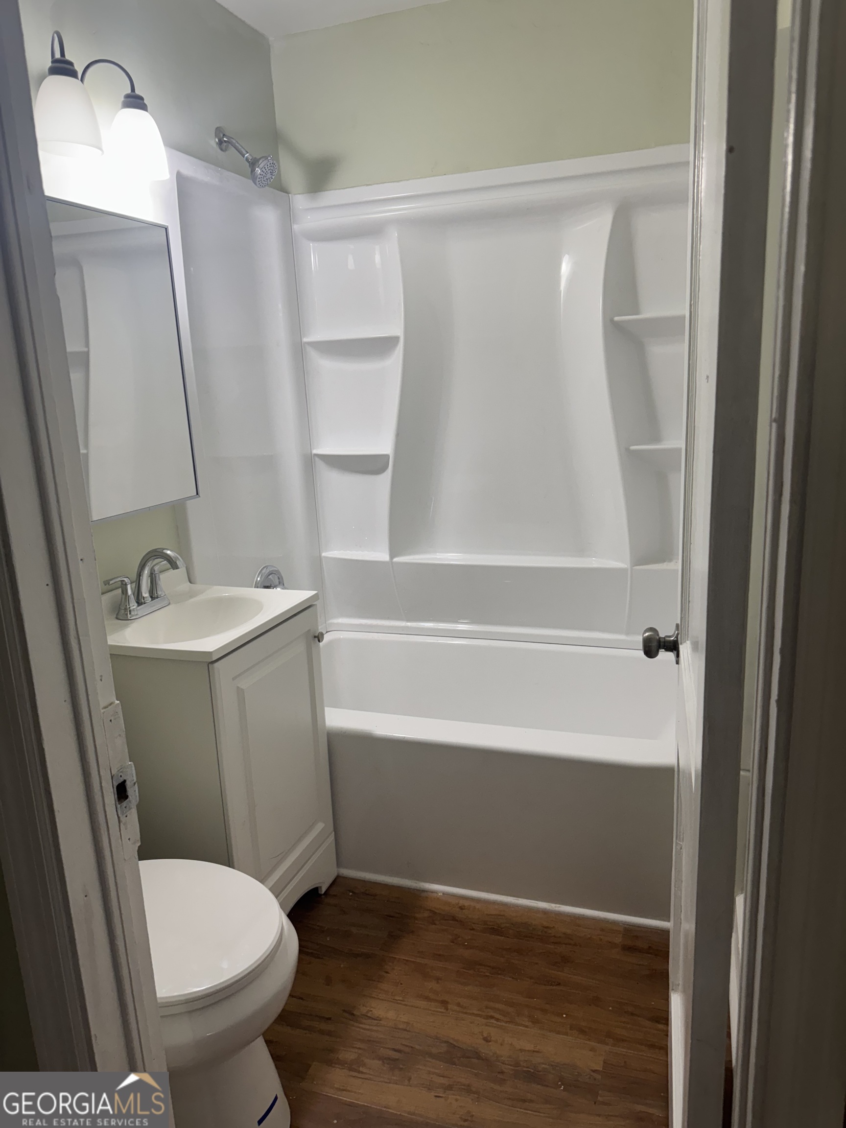 906 Central Avenue Dublin, GA 31021 - Photo 14 of 15 a bathroom with a toilet and a shower