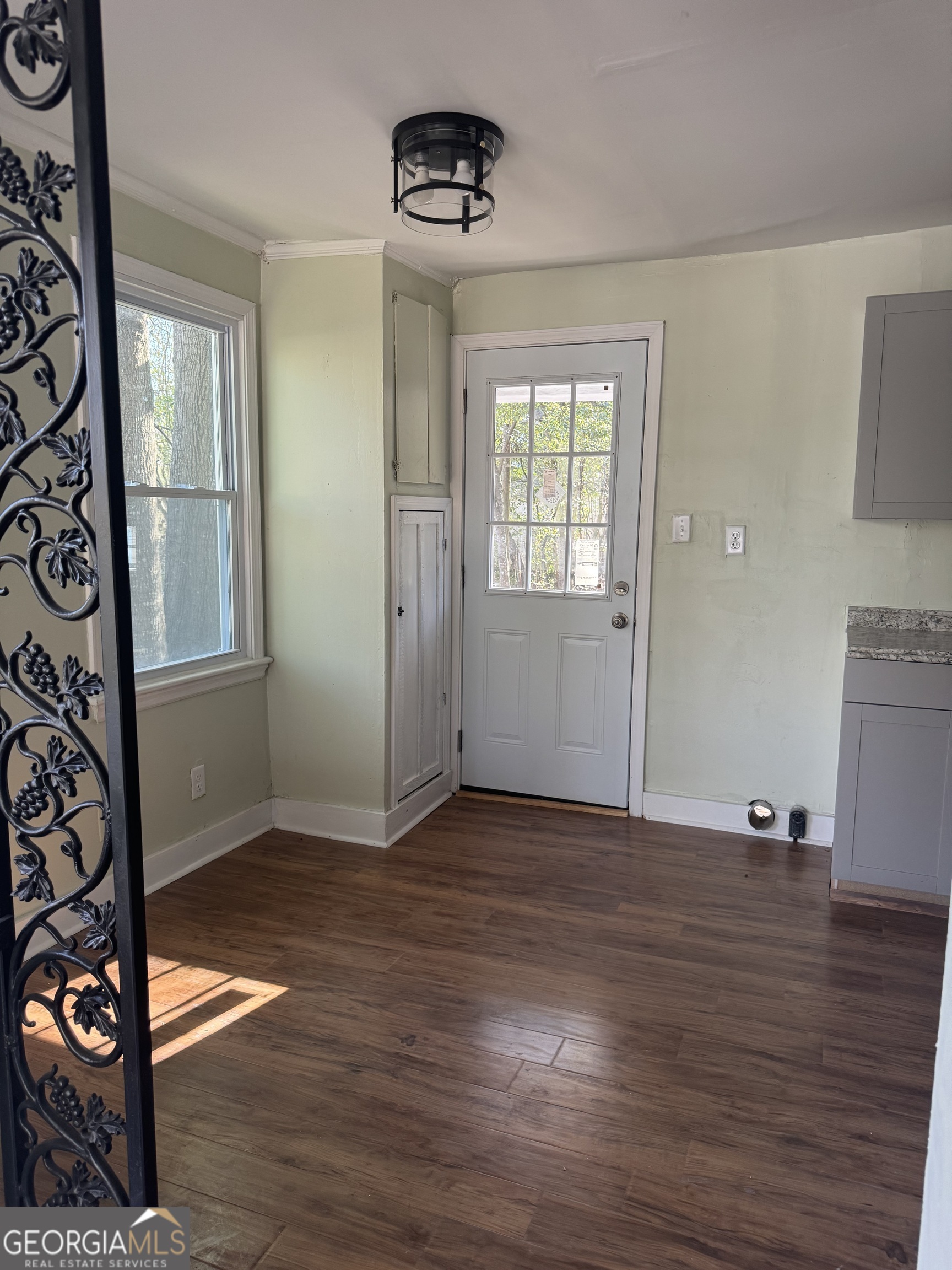 906 Central Avenue Dublin, GA 31021 - Photo 3 of 15 wooden floor in an empty room with a window