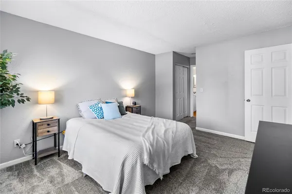 a bedroom with a bed and a lamp