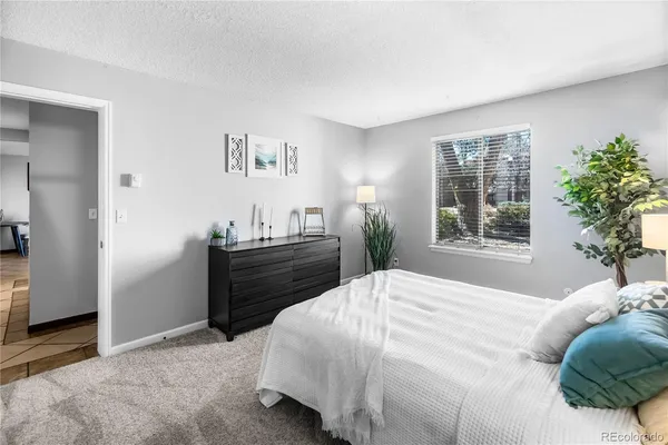 a bedroom with a bed and a lamp