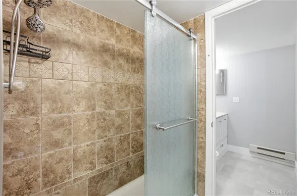 a bathroom with a shower and a sink