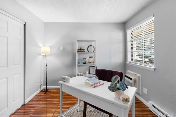 a view of a workspace with furniture and a window