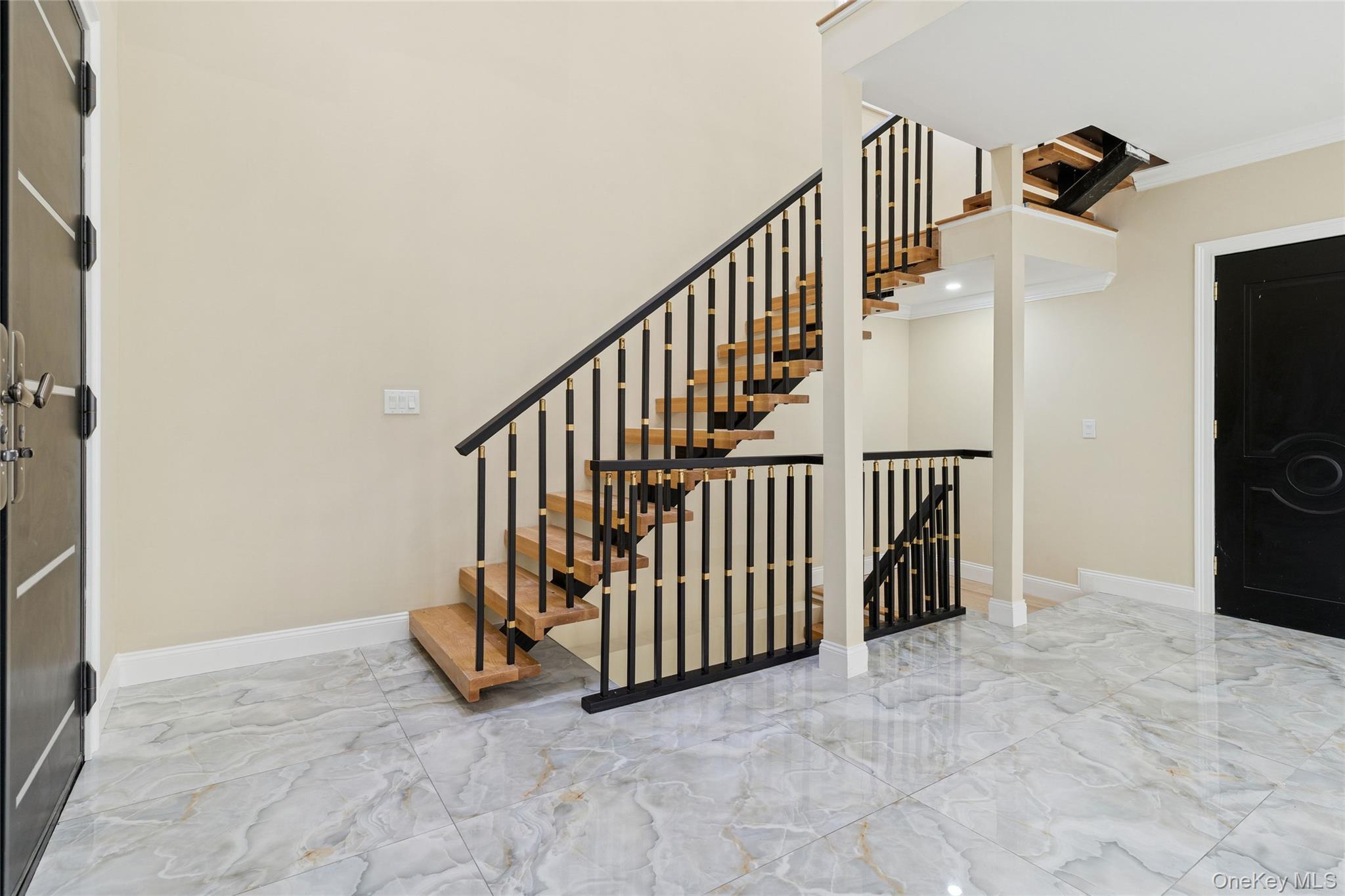 81-25 265th Street Queens, NY 11004 - Photo 11 of 44 Staircase with tiled floors ornamental molding
