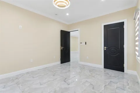 a view of a room with a window and a ceiling fan