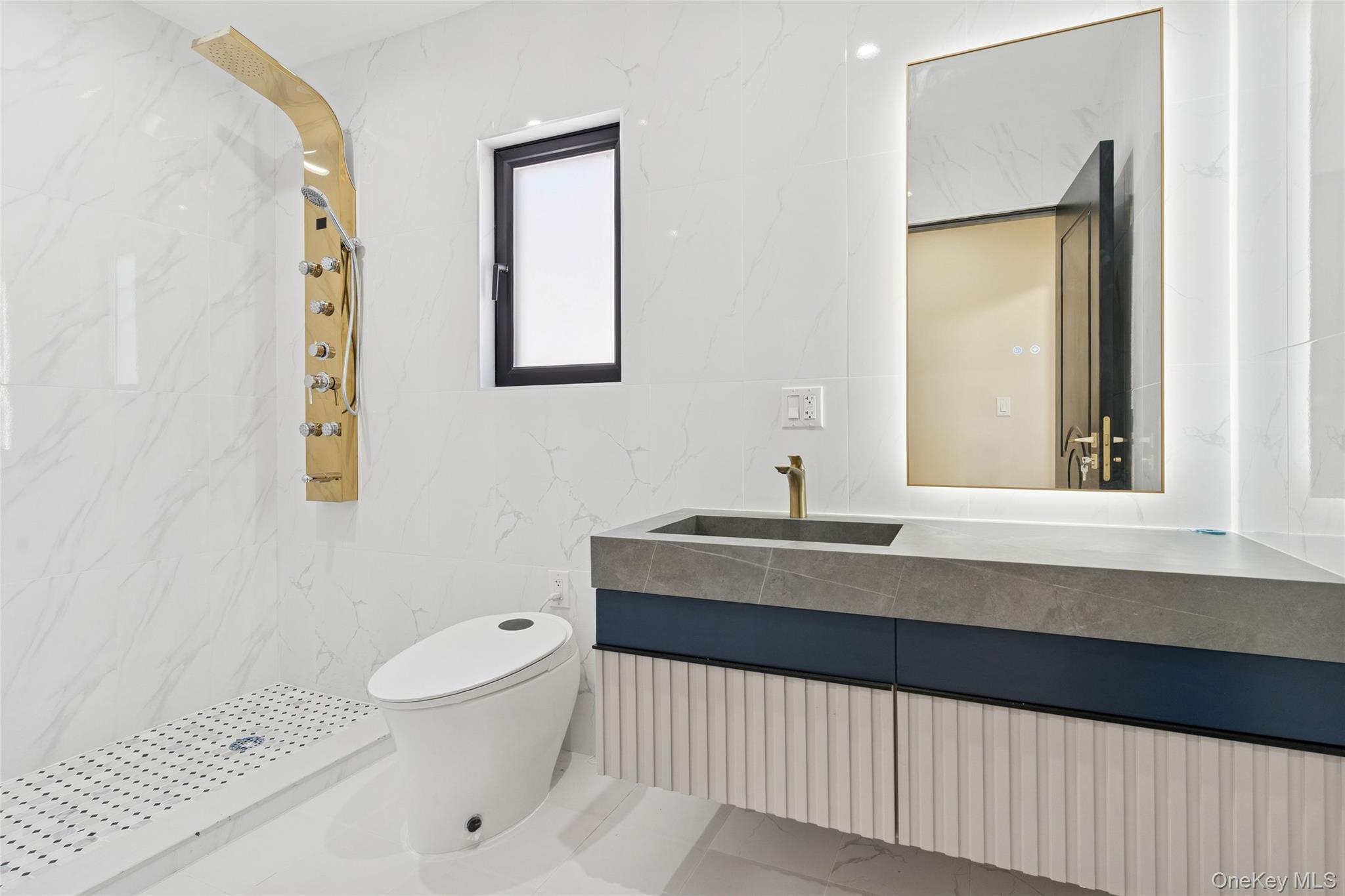 81-25 265th Street Queens, NY 11004 - Photo 27 of 44 Bathroom with vanity, tile walls, smart toilet, smart mirror, shower jet