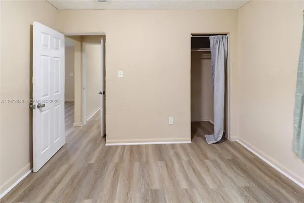 a view of a room with wooden floor