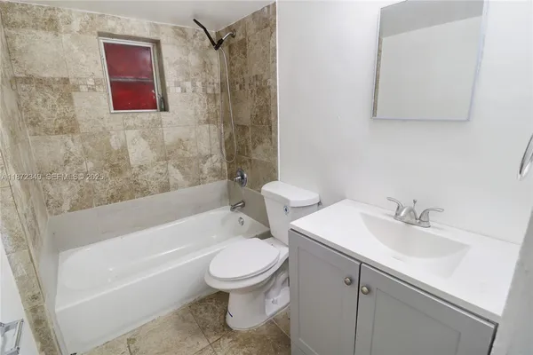 a bathroom with a toilet sink and bathtub