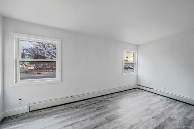 wooden floor in an empty room with a window