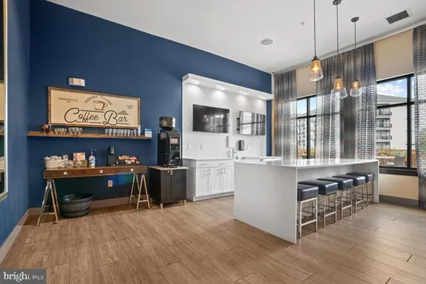 a dining room with furniture and a kitchen view