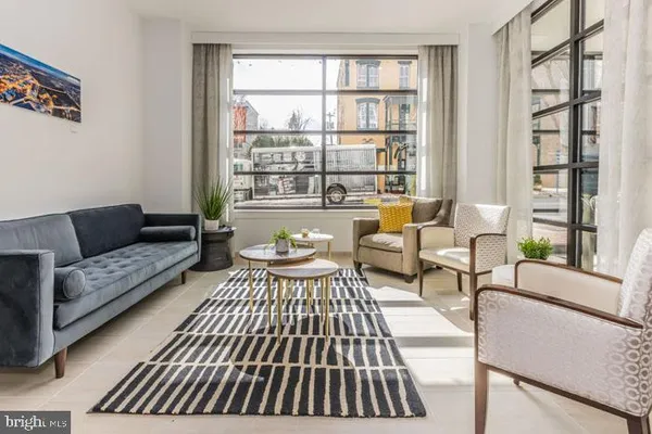 a living room with furniture and a large window