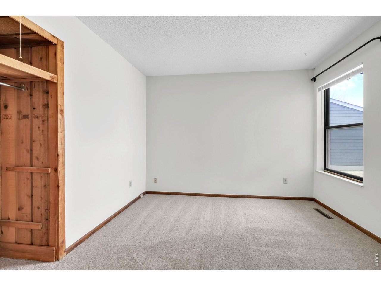 4268 Corriente Place Boulder, CO 80301 - Photo 14 of 35 an empty room with wooden floor and windows