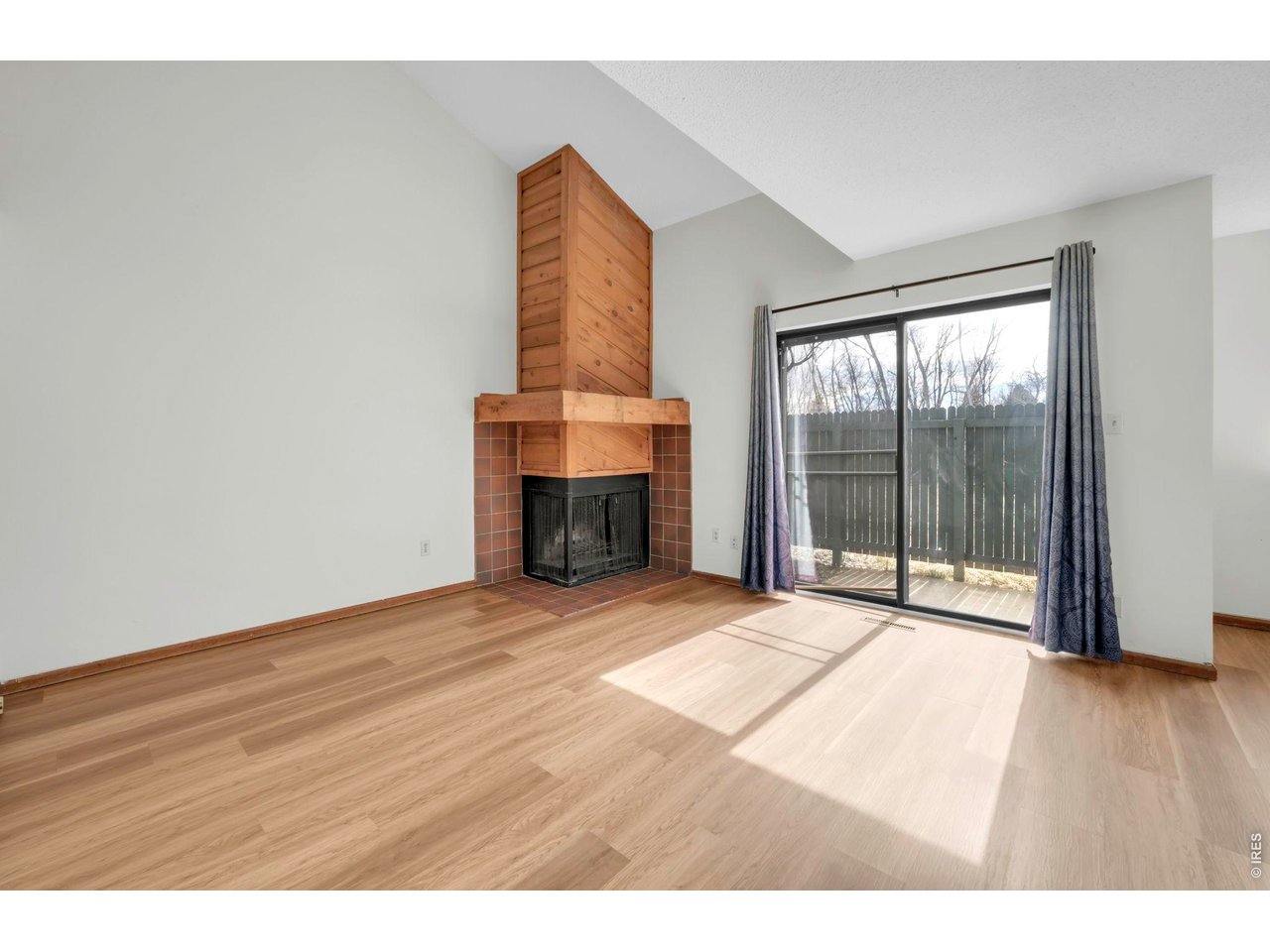 4268 Corriente Place Boulder, CO 80301 - Photo 3 of 35 a view of an empty room with wooden floor and a window