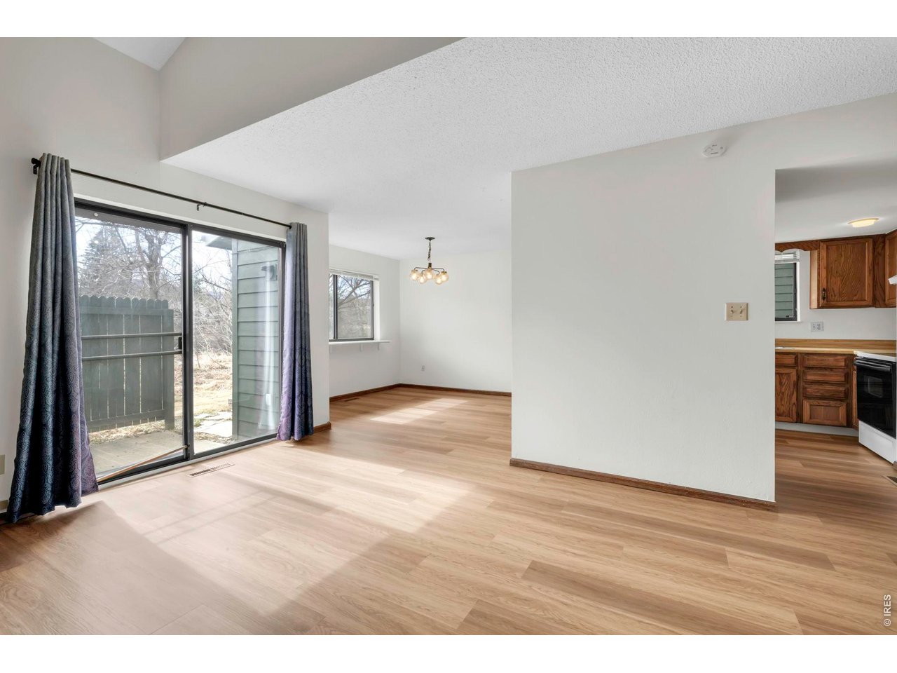 4268 Corriente Place Boulder, CO 80301 - Photo 5 of 35 a view of an empty room with a window and wooden floor