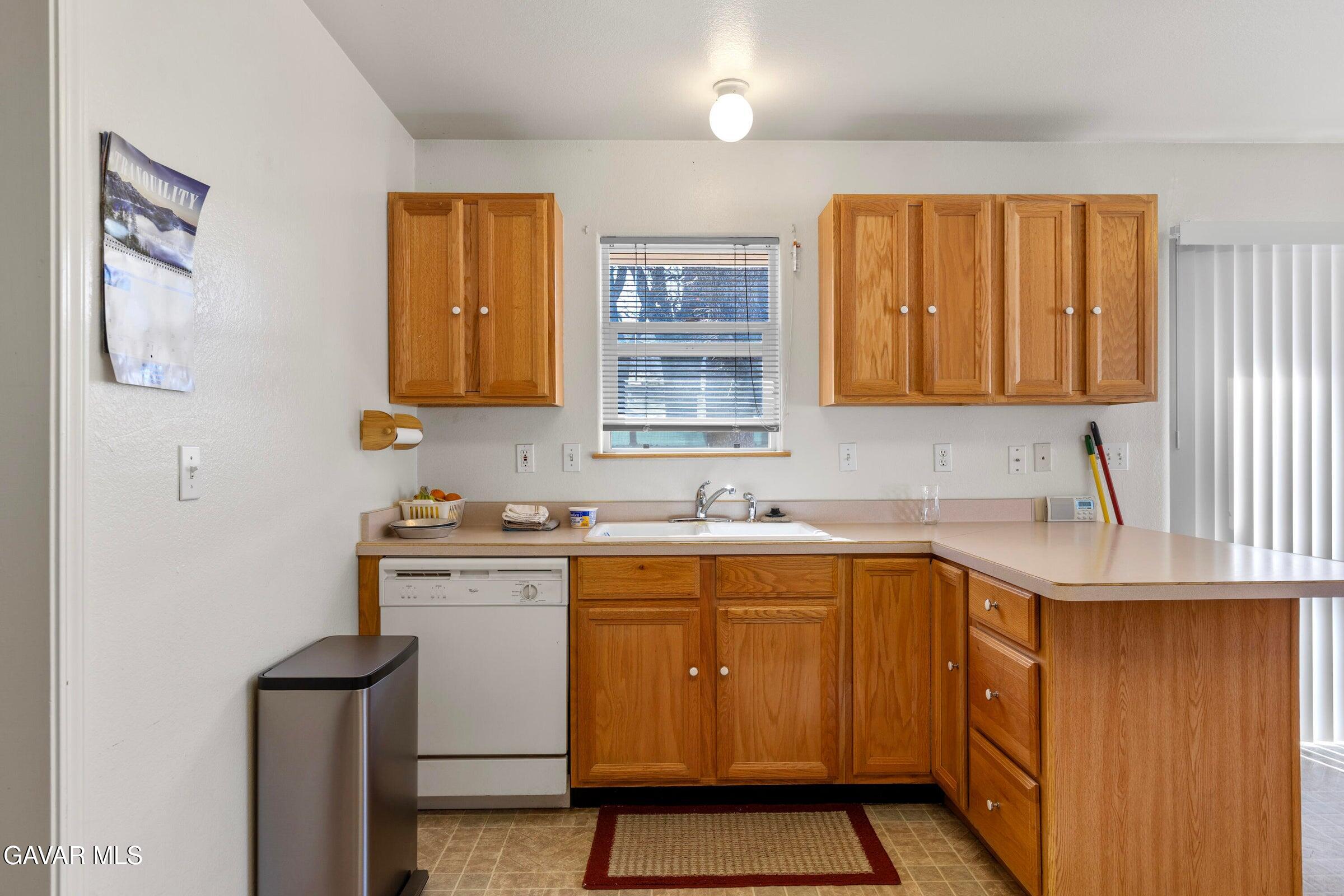 18330 Basil Drive Tehachapi, CA 93561 - Photo 13 of 47 a kitchen with a sink stove and cabinets