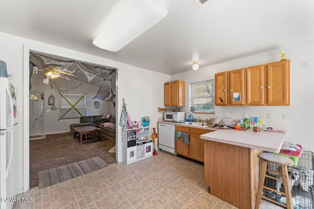 a kitchen filled a sink stove top oven and cabinets