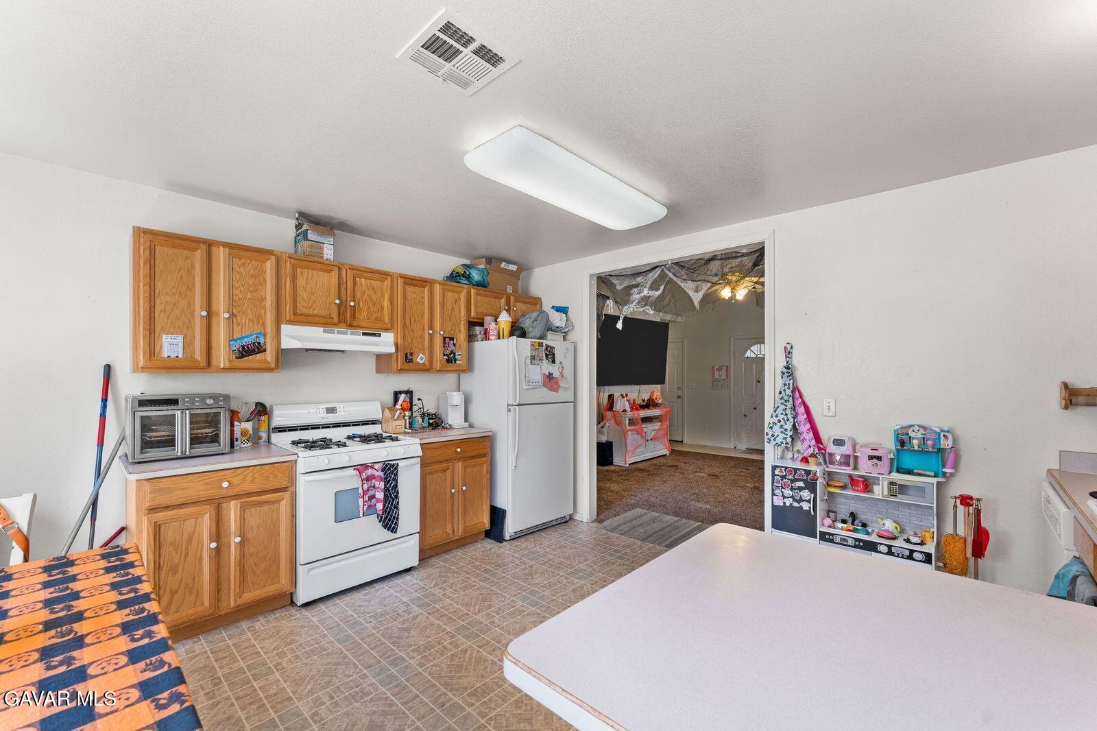 18330 Basil Drive Tehachapi, CA 93561 - Photo 18 of 47 a bed room with a bed and a dresser