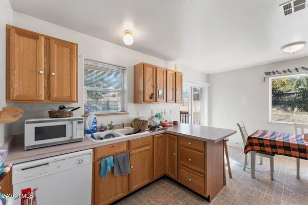 a kitchen that has a sink and a stove in it