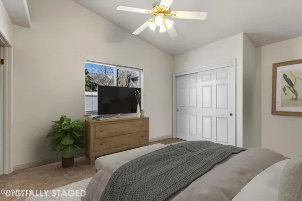 a bedroom with a bed and a flat screen tv