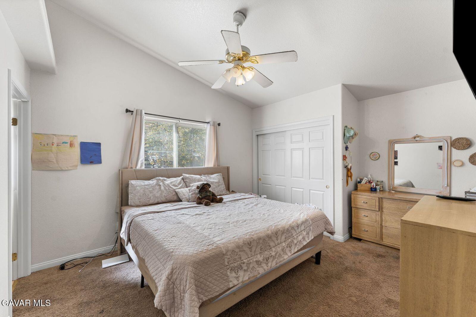 18330 Basil Drive Tehachapi, CA 93561 - Photo 25 of 47 a bedroom with a bed and a chandelier