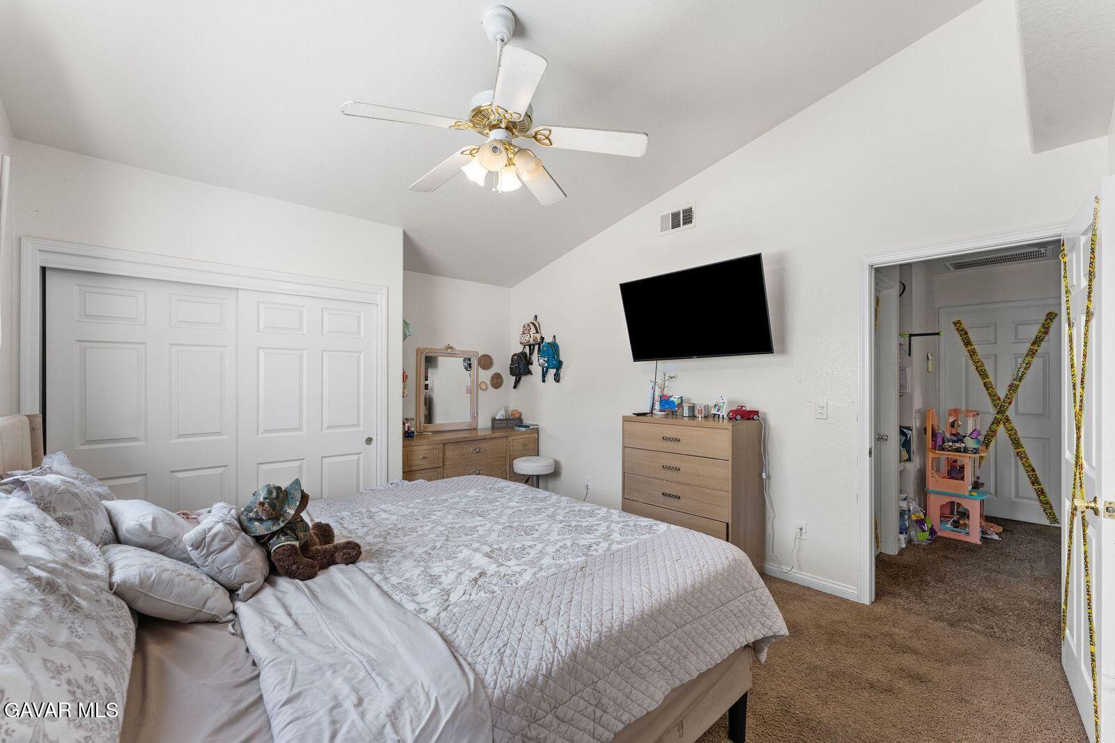 18330 Basil Drive Tehachapi, CA 93561 - Photo 26 of 47 a bedroom with a bed and a flat tv screen on dresser