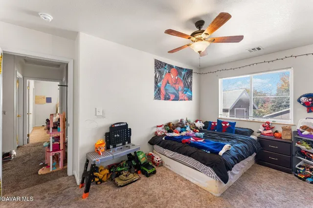 a bedroom with furniture and a large window
