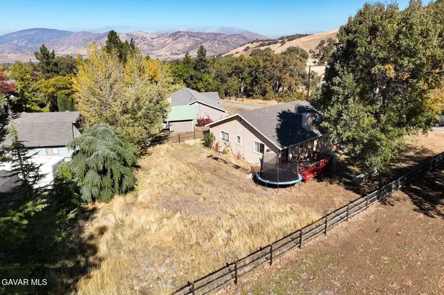 a view of a house with a yard and sitting area