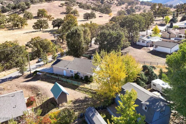 an aerial view of a house with a yard and lake view
