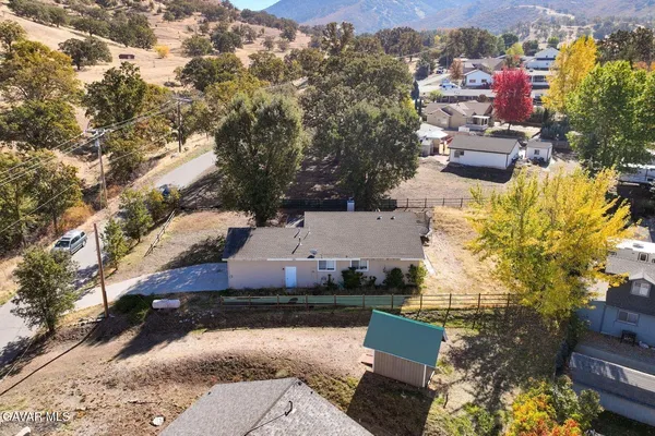 an aerial view of multiple houses with yard