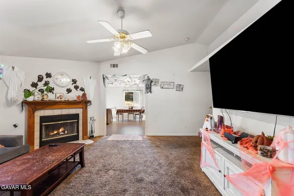 a living room with furniture and a fireplace
