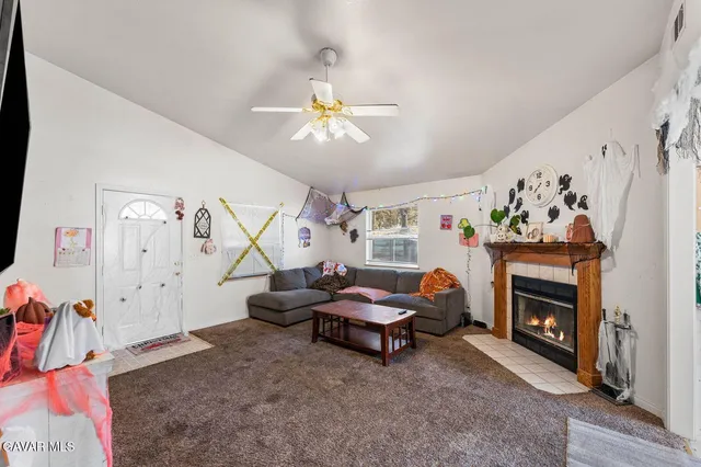 a living room with furniture and a fireplace