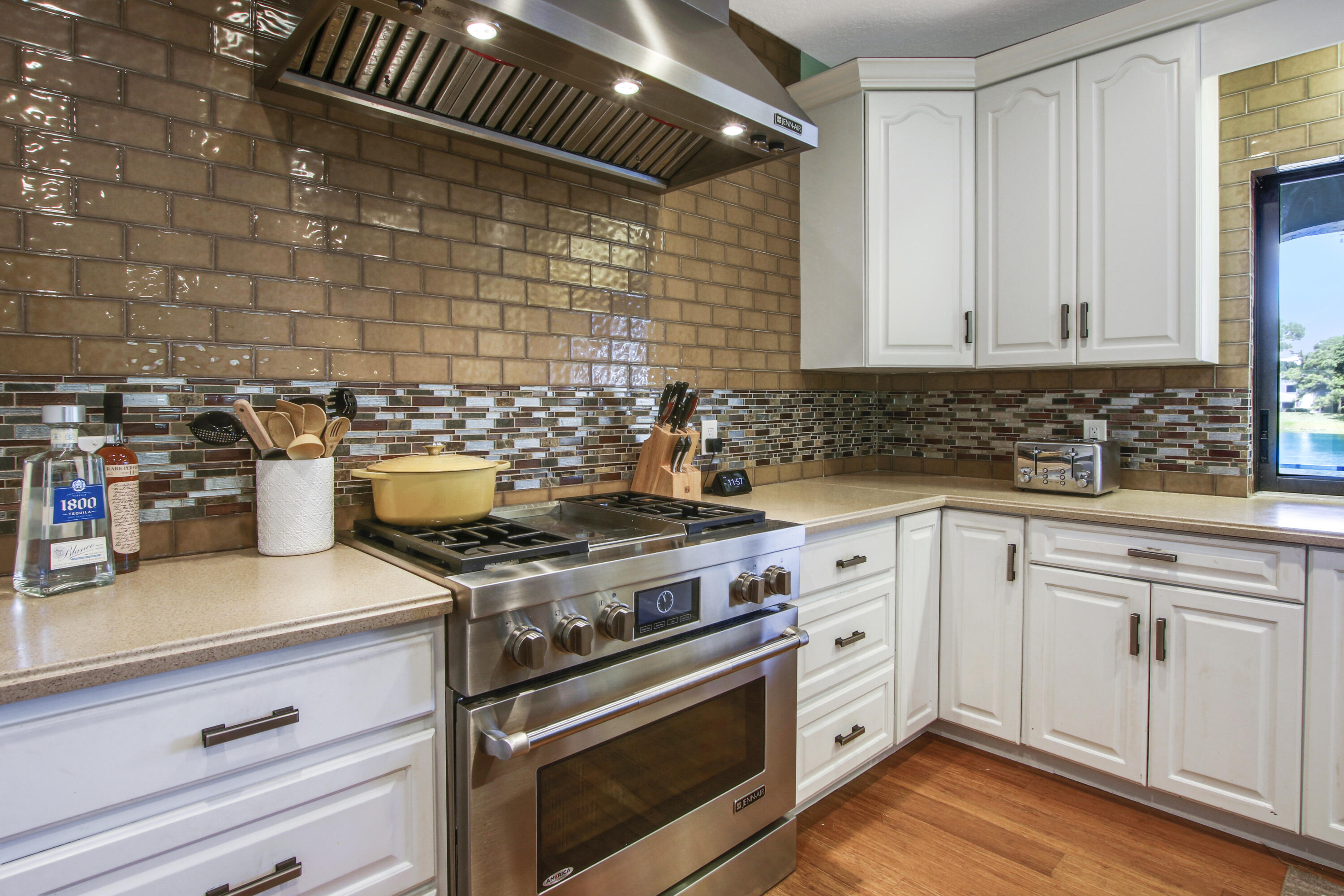 6369 Longleaf Pine Drive Jupiter, FL 33458 - Photo 12 of 53 a kitchen with a stove and white cabinets