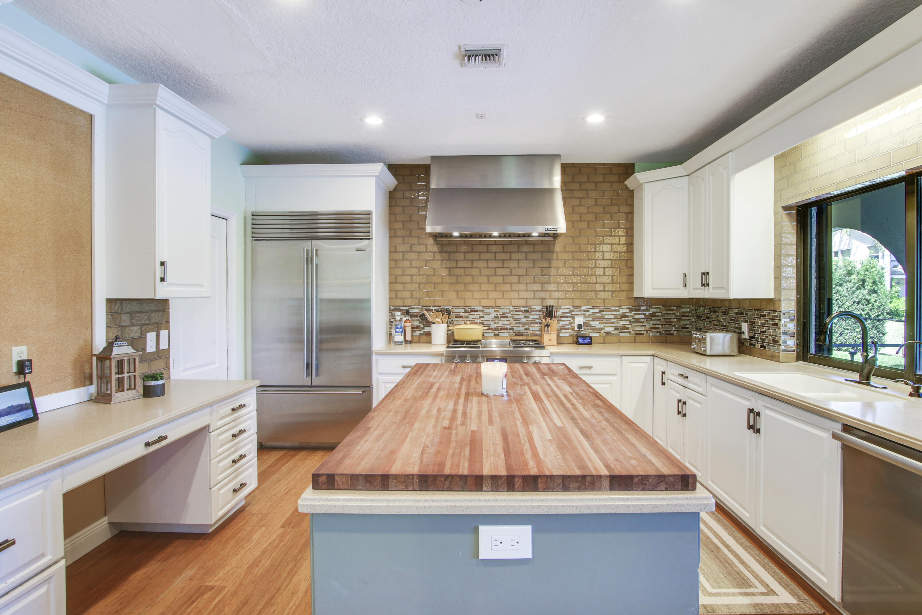 6369 Longleaf Pine Drive Jupiter, FL 33458 - Photo 14 of 53 a large kitchen with kitchen island a sink stainless steel appliances and cabinets